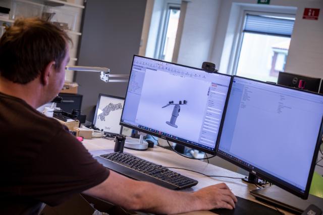 Photo of a product designer working on a custom product design using CAD software